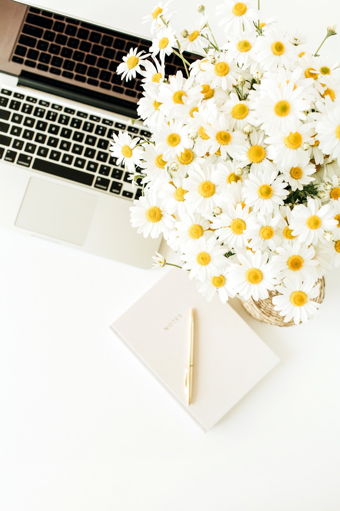 Desk with Flowers and a Laptop